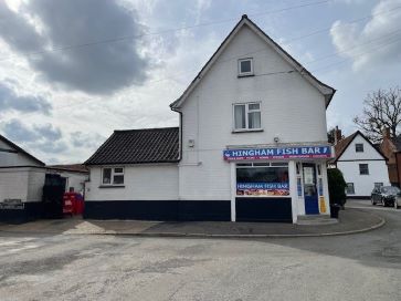 Road side view of the property and shop front